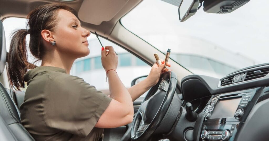 woman driver putting on makeup