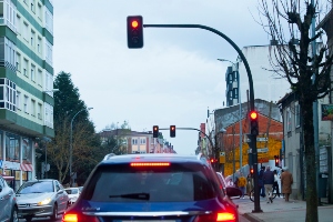 A car at a red light traffic signal.