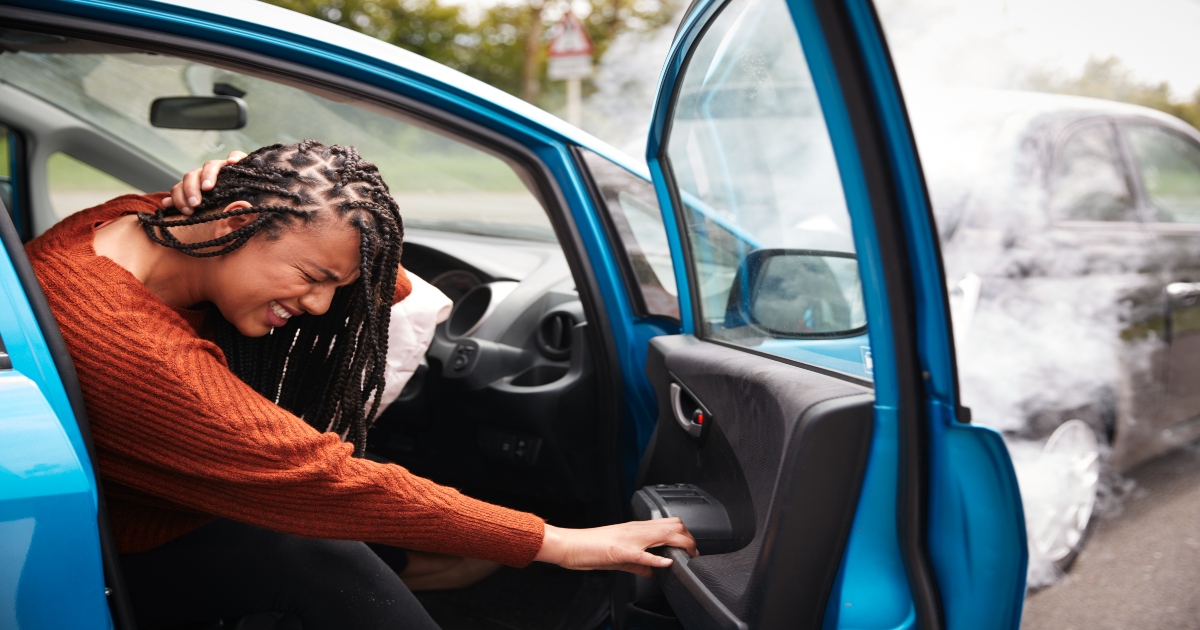 Women hurt, holding her neck after a car accident.