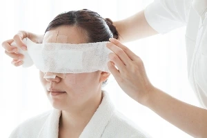 Facial bandages on a patient's head.