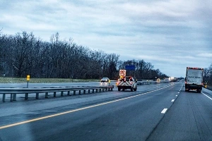 A highway with a U-turn sign.