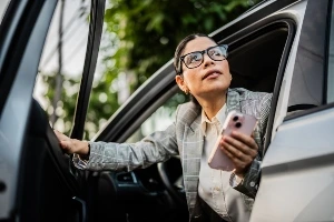 A woman getting out of a car. 