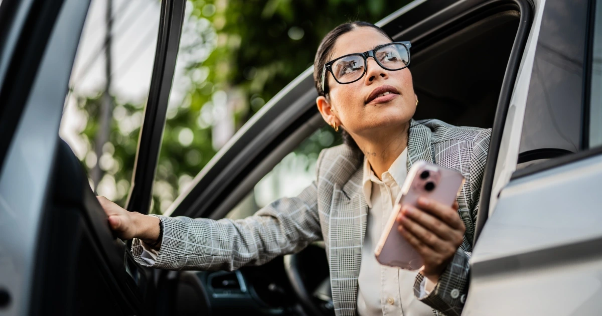 A woman getting out of a car.