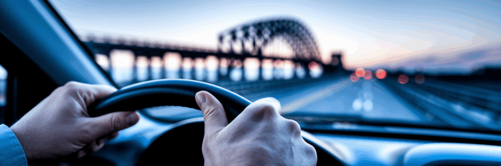 Anxious driver's hands on steering wheel.