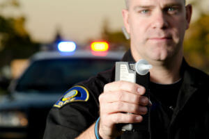 police officer with breathalyzer