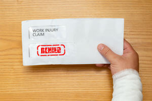 hand holding workers comp claim denied letter