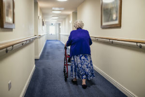 nursing home resident walking down hallway
